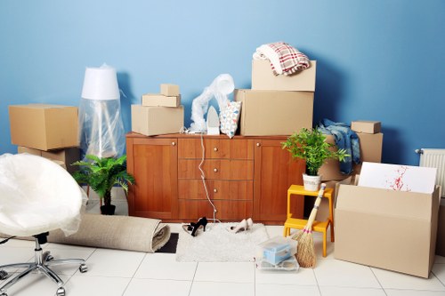 Moving boxes and furniture being handled during a removals service