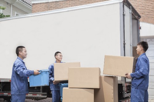 Professional moving team packing household items for transport