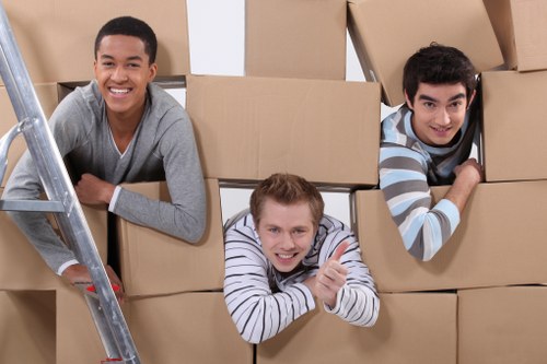 A moving team loading items into a van for a Hampton house move